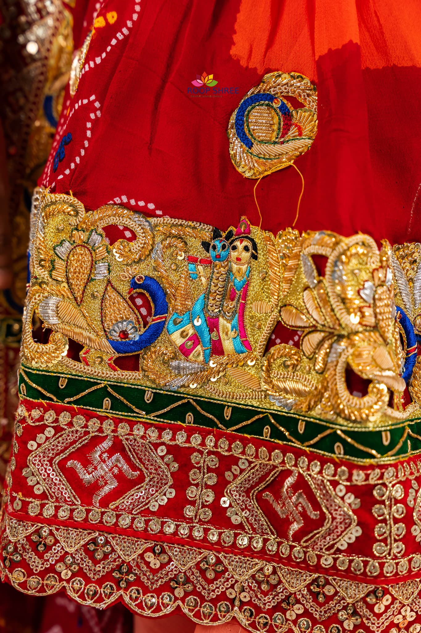 Traditional odhna adorned with Radha Krishna brooch for divine elegance.