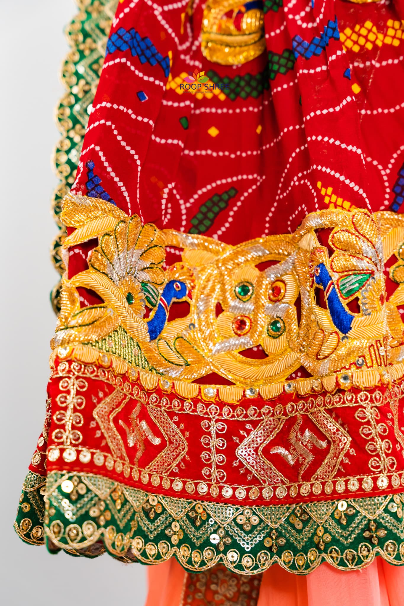 Elegant odhna with one-side brooch featuring Swastik Belbuti work.