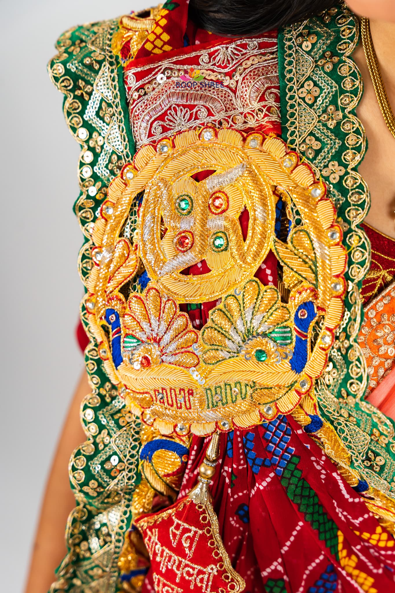 Elegant odhna with one-side brooch featuring Swastik Belbuti work.