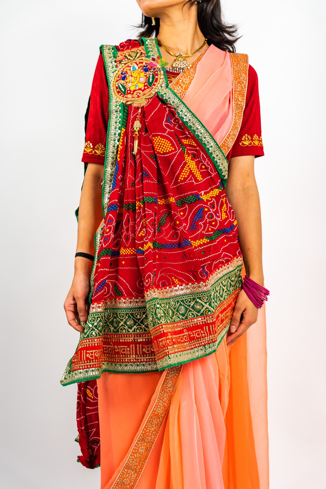 Traditional odhna adorned with  Ganesh brooch for divine elegance.