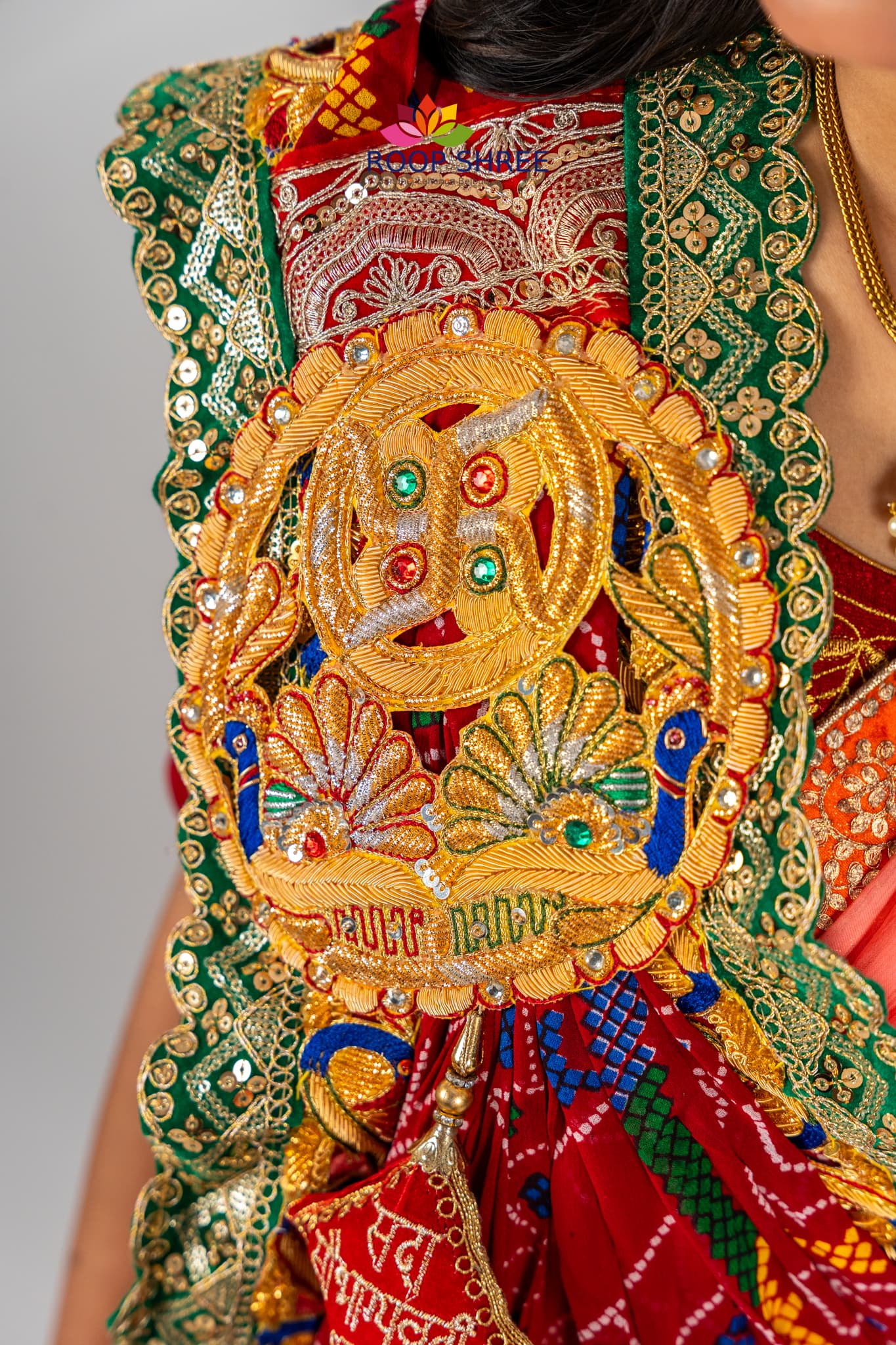 Elegant odhna with one-side brooch featuring Swastik Belbuti work.