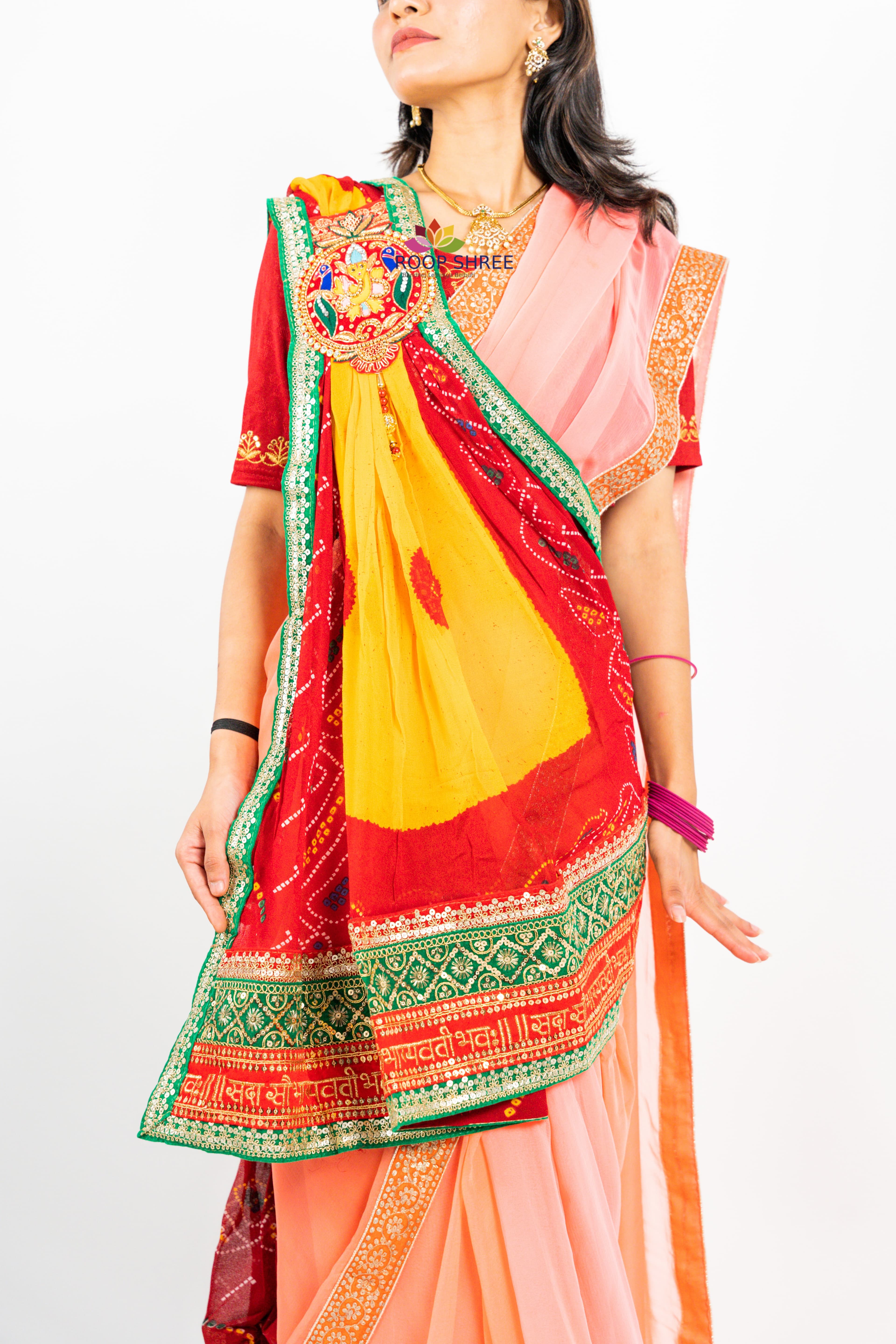 Traditional odhna adorned with  Ganesh brooch for divine elegance.