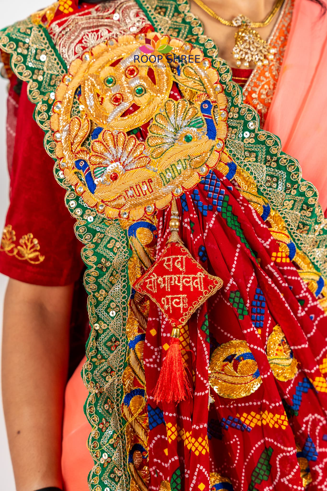 Elegant odhna with one-side brooch featuring Swastik Belbuti work.